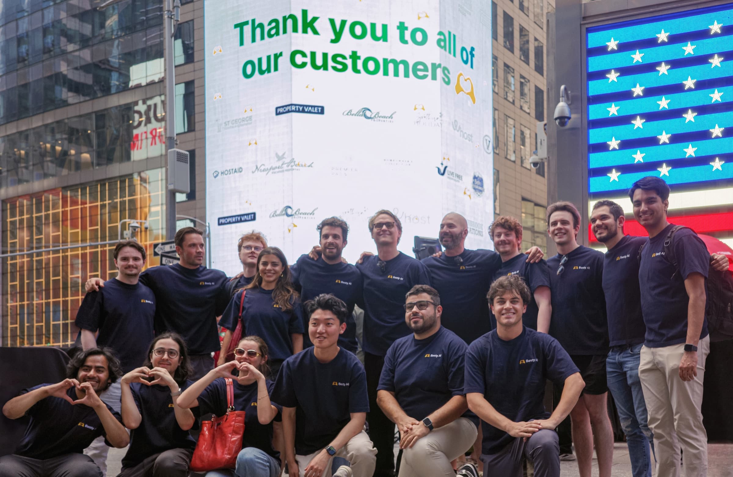 The Besty AI team gathered in Times Square in front of a billboard thanking customers
