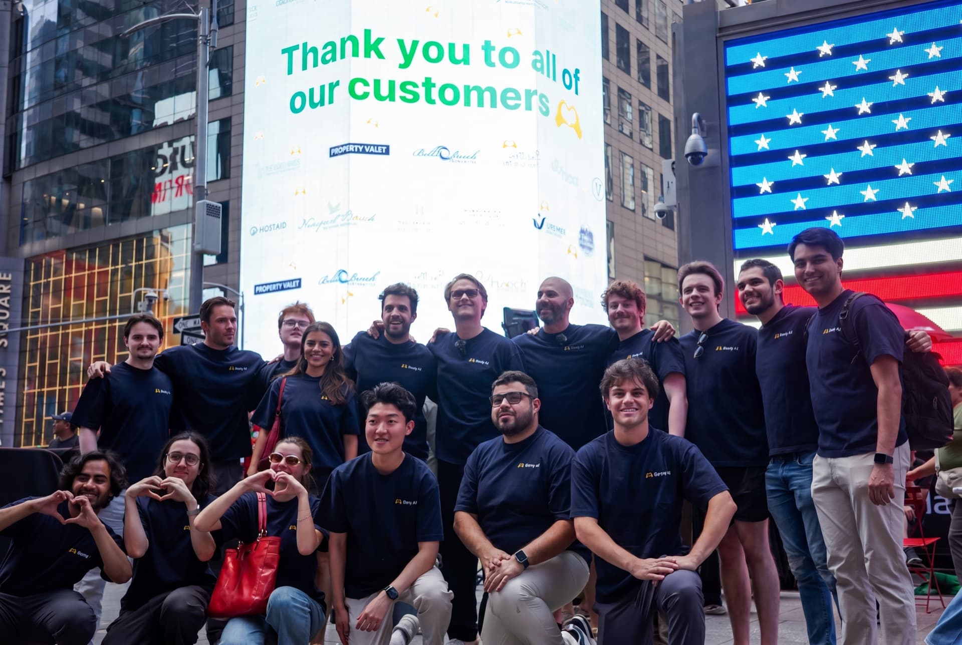 The Besty AI team gathered in Times Square in front of a billboard thanking customers